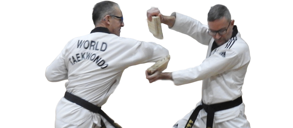 World Taekwondo demonstration of power breaking using the elbow strike, Mark Mitchell breaking 2 thick pine boards with his elbow while Justin Kerr holds the boards for him in place with his two hands.